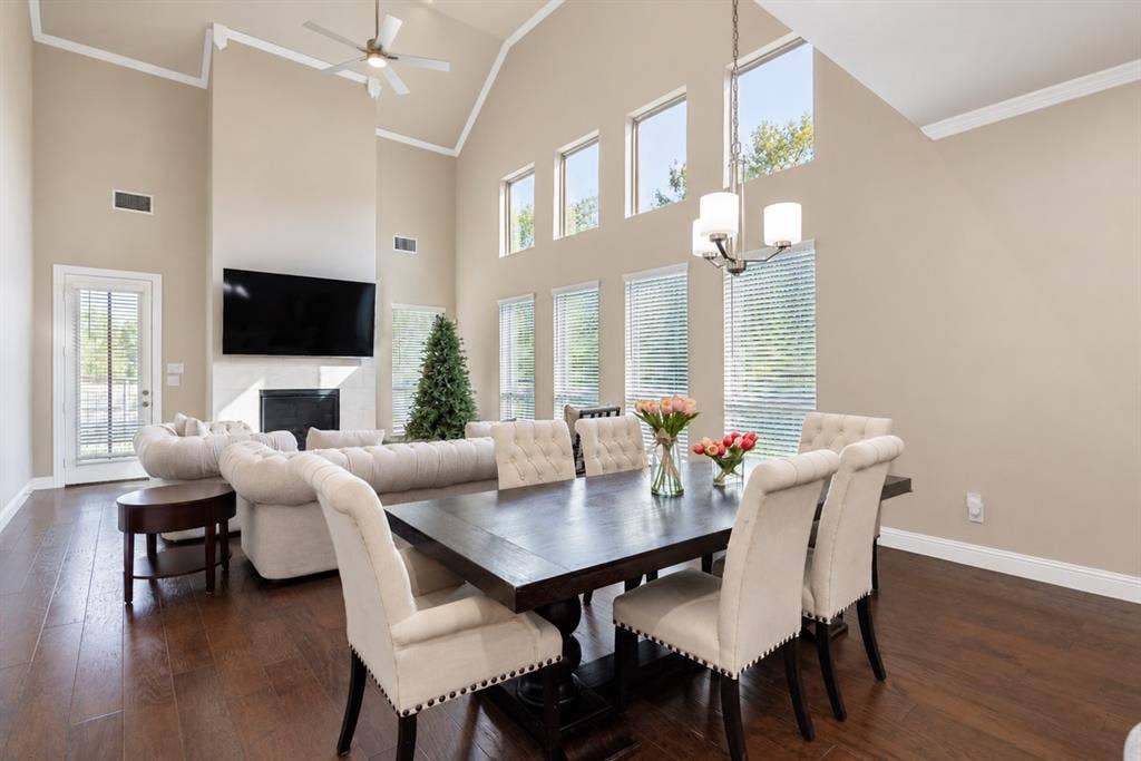1603 Coventry Court, Farmers Branch, TX 75234 Vaulted ceiling with crown molding, elevated windows, wood-finish flooring, fireplace with a mantle, and recessed lighting