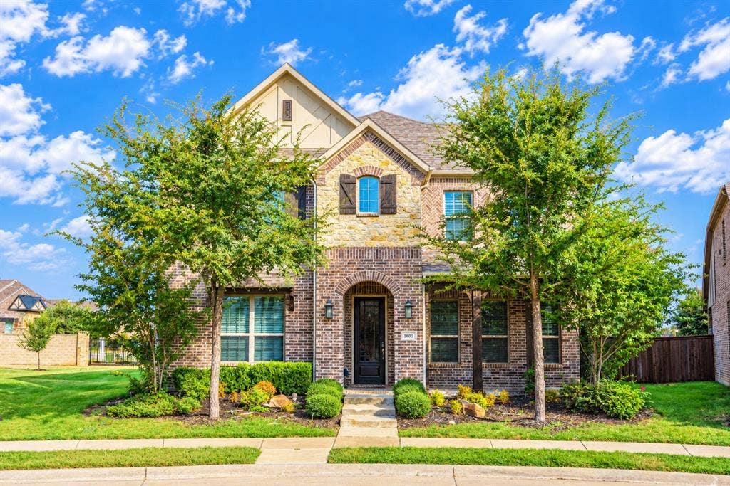 1603 Coventry Court, Farmers Branch, TX 75234 Brick and stone facade with arched entry, complementing shutters, and a gabled roofline