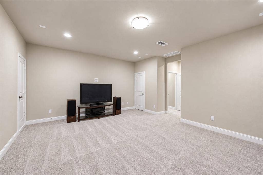 1603 Coventry Court, Farmers Branch, TX 75234 Spacious room with light-colored carpet, recessed lighting, and a ceiling-mounted light fixture
