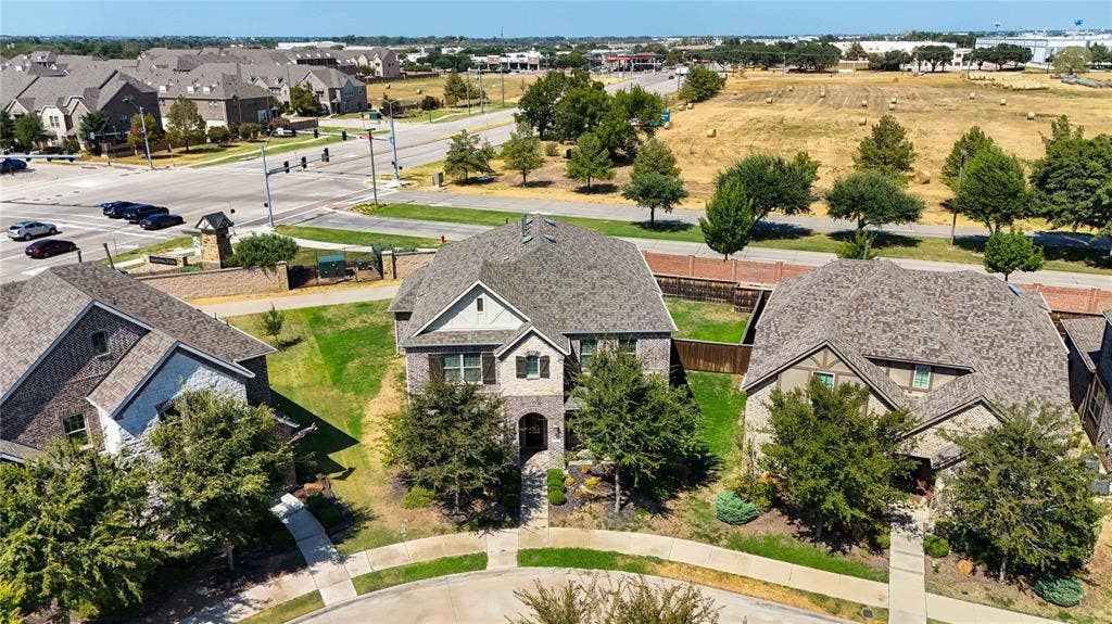 1603 Coventry Court, Farmers Branch, TX 75234 Gabled roofline, stone and siding exterior, front landscaping, concrete walkway, and paved driveway
