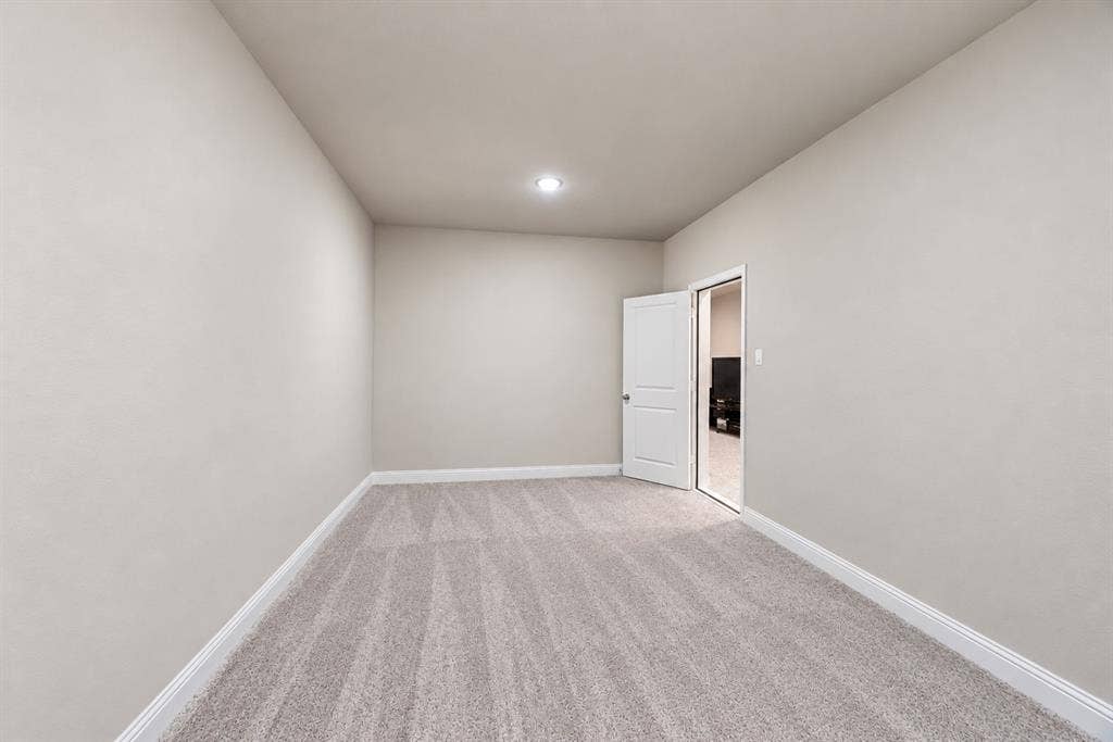 1603 Coventry Court, Farmers Branch, TX 75234 Recessed ceiling lighting, light gray wall paint, gray patterned carpeting, white trim, and a white interior door