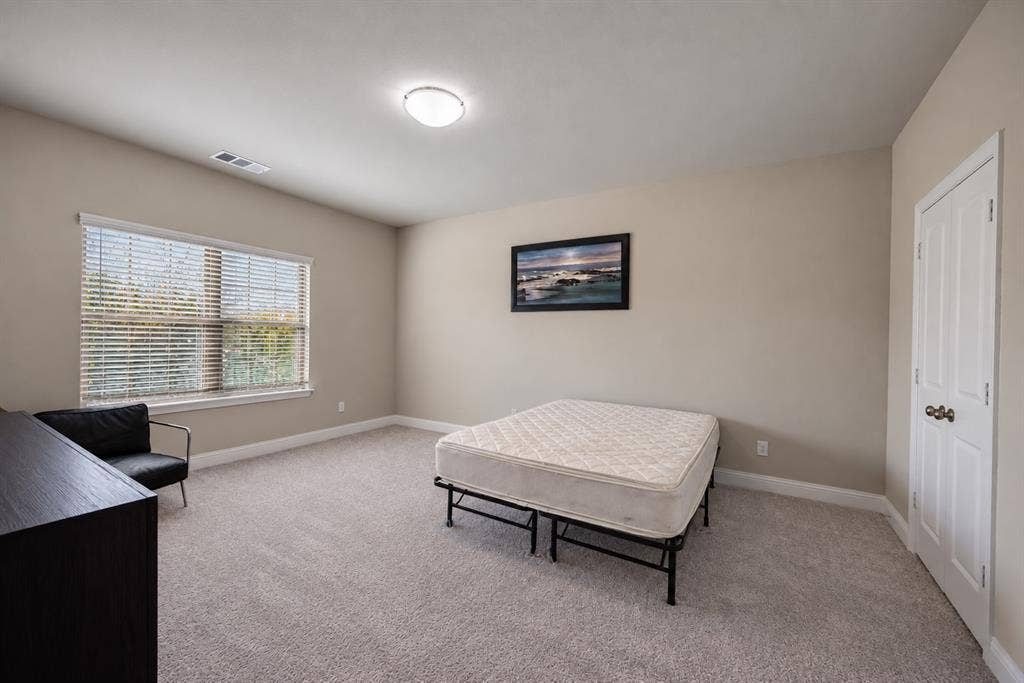 1603 Coventry Court, Farmers Branch, TX 75234 Wall-to-wall carpeting, window with blinds, recessed lighting, and a paneled door with dark hardware