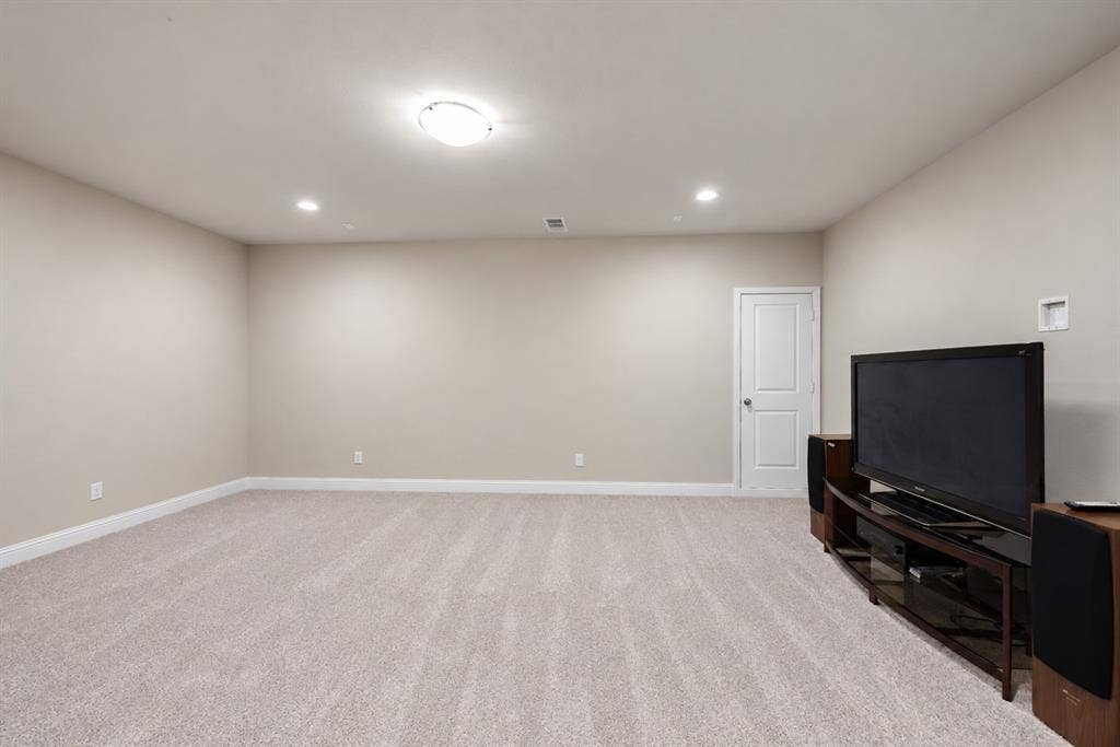 1603 Coventry Court, Farmers Branch, TX 75234 Recessed lighting, flush mount lighting, light beige carpeting, white interior door, and light neutral wall paint