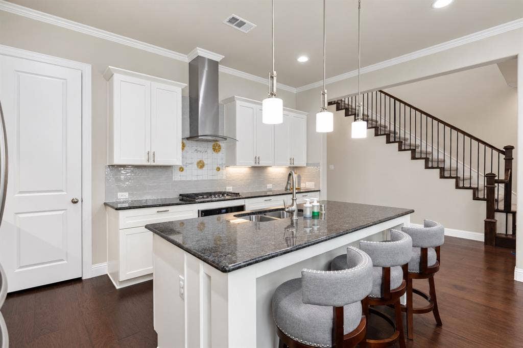 1603 Coventry Court, Farmers Branch, TX 75234 Kitchen with white cabinetry, dark stone countertops, and a full tile backsplash