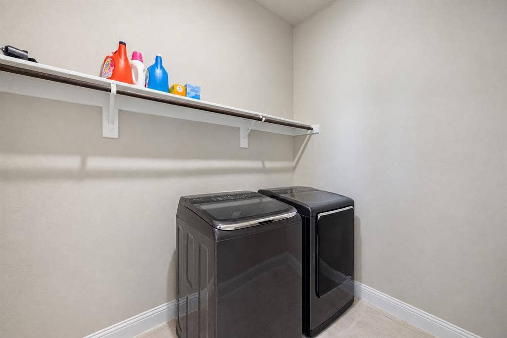 1603 Coventry Court, Farmers Branch, TX 75234 Laundry area featuring a built-in shelf and clothing rod