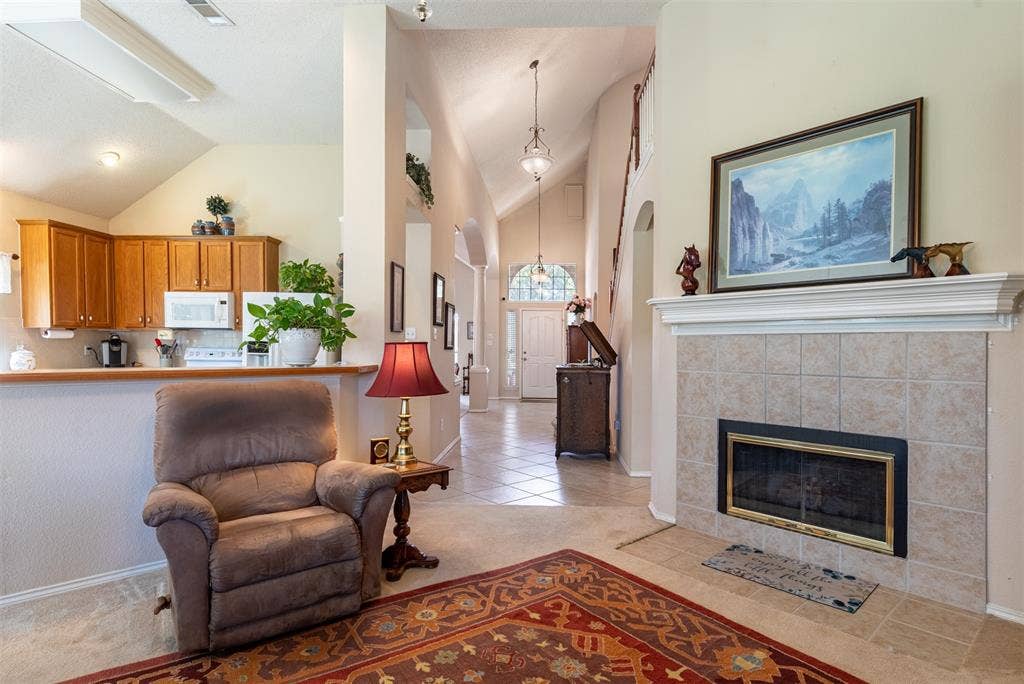 10208 Noel Drive, Frisco, TX 75035 Living room with cozy fireplace.