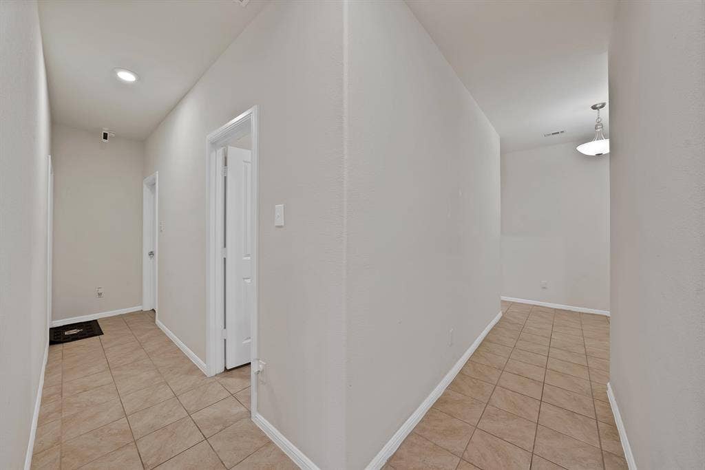 228 Foxhunter Street, Fort Worth, TX 76131 Neutral wall paint, tile flooring, recessed ceiling lighting, interior doors with white trim, and a ceiling-mounted light fixture