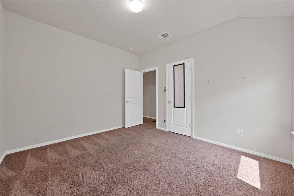228 Foxhunter Street, Fort Worth, TX 76131 Light brown carpeted flooring, neutral wall tones, white interior doors, and overhead lighting