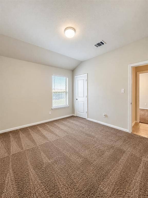 228 Foxhunter Street, Fort Worth, TX 76131 Carpeted room with vaulted ceiling and flush mount lighting