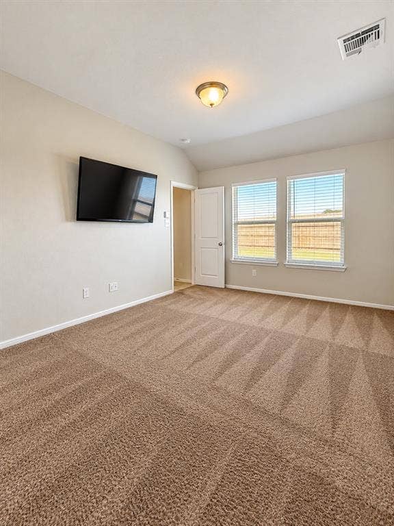 228 Foxhunter Street, Fort Worth, TX 76131 Carpeted room featuring multiple windows, a ceiling-mounted light fixture, and a wall-mounted display
