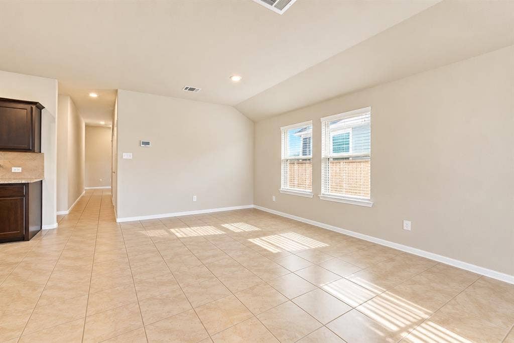 228 Foxhunter Street, Fort Worth, TX 76131 Open-concept living space with tile flooring, recessed lighting, and a vaulted ceiling
