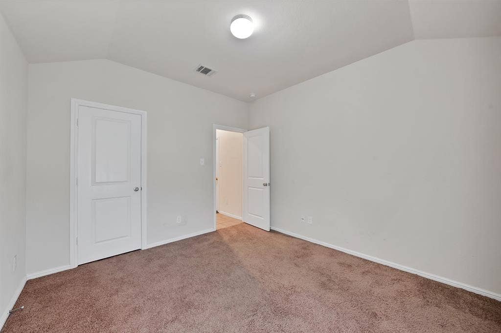 228 Foxhunter Street, Fort Worth, TX 76131 Neutral wall paint, vaulted ceiling, recessed lighting, and carpet flooring