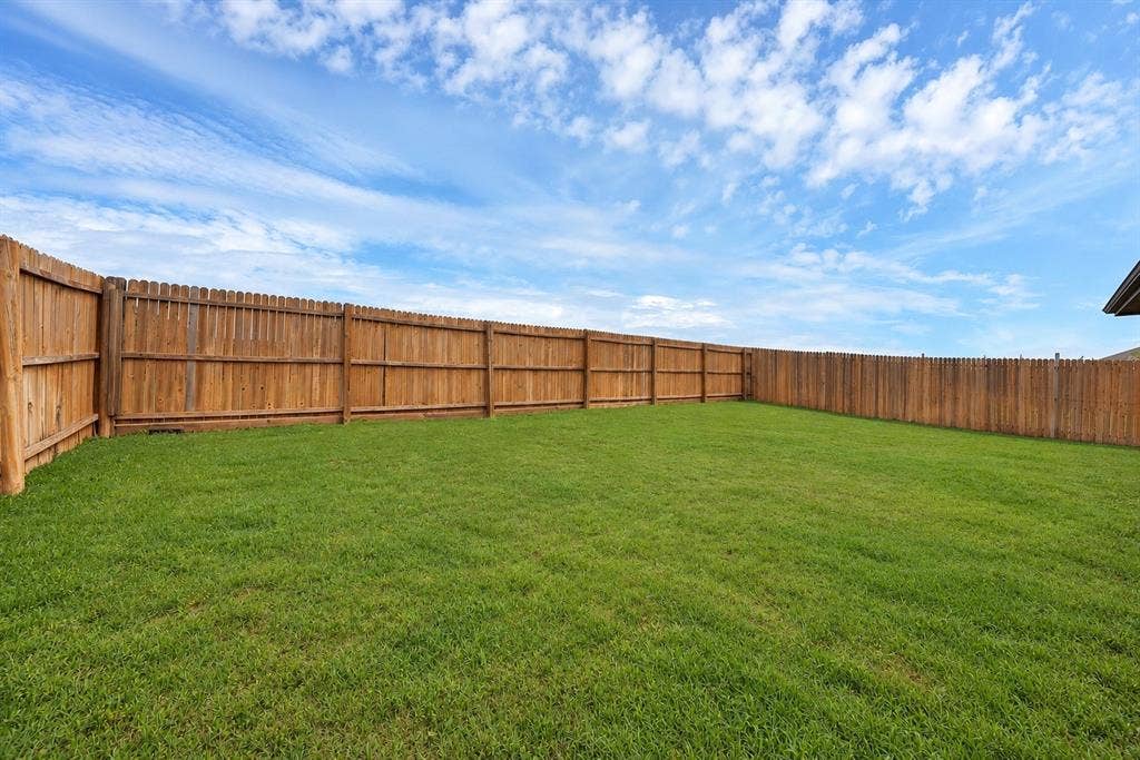228 Foxhunter Street, Fort Worth, TX 76131 Expansive grassy yard with a wood privacy fence