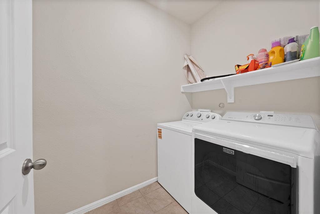 228 Foxhunter Street, Fort Worth, TX 76131 Laundry area featuring a built-in shelf and tile flooring