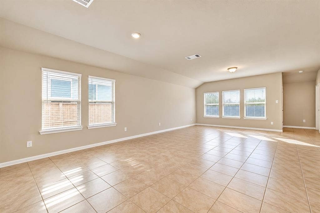 228 Foxhunter Street, Fort Worth, TX 76131 Spacious room featuring tile flooring, neutral wall tones, multiple windows with blinds, recessed lighting, and a flush mount light fixture