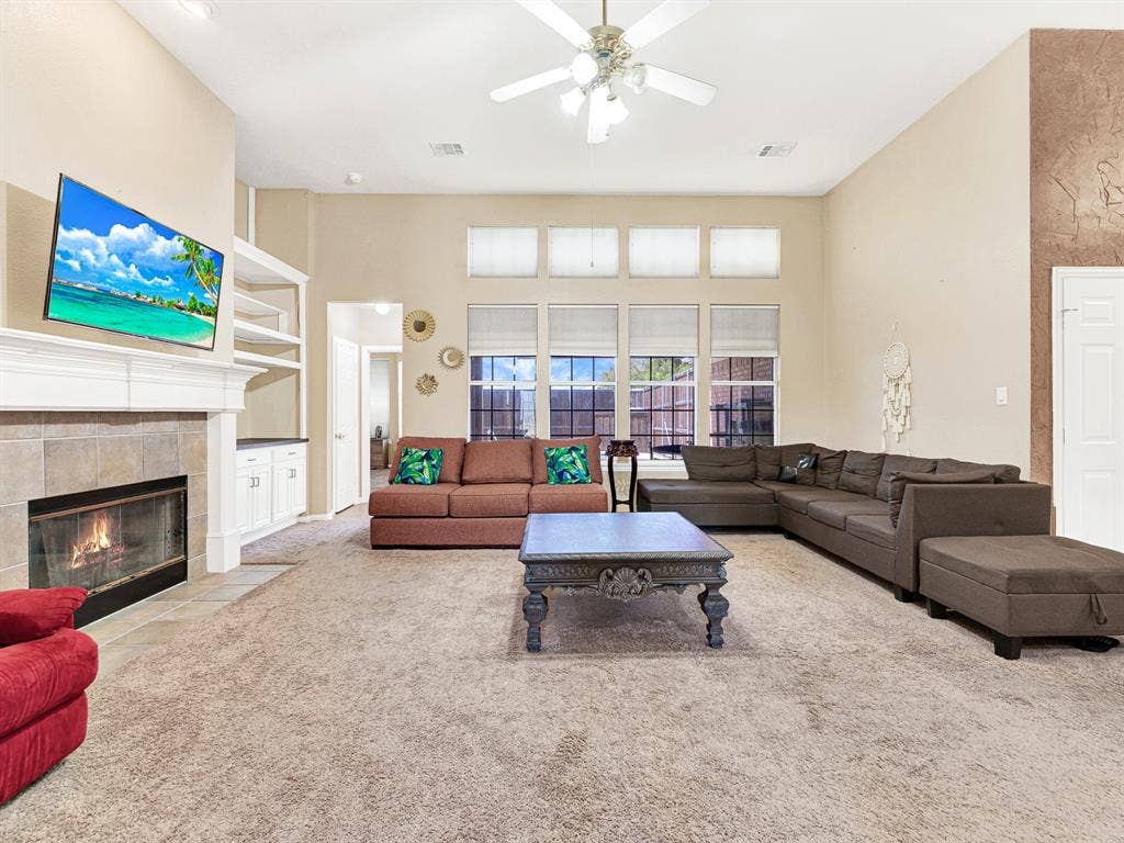 Four tall windows frame the backyard pool, making the outdoor retreat part of the family room’s everyday view. Enjoy a relaxed afternoon indoors while sunlight dances on the water outside.