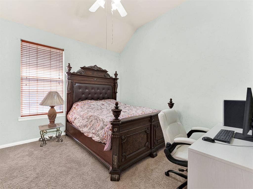 A raised ceiling gives this secondary bedroom breathing room, while a tall side window filters daylight across softly textured walls. Make bedtime a calm ritual with a favorite story and a few quiet minutes together.