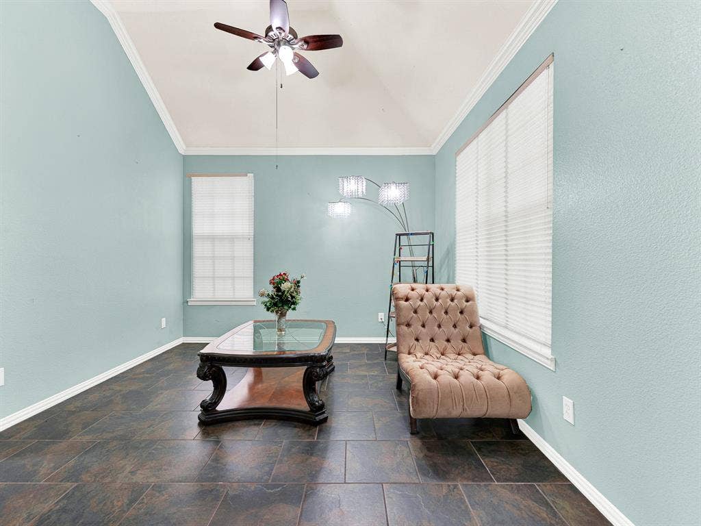 Windows on two walls brighten this flexible room, while earthy tile flooring adds warmth and texture. Make it your own creative retreat for sketching, practicing music, or settling into a favorite hobby.