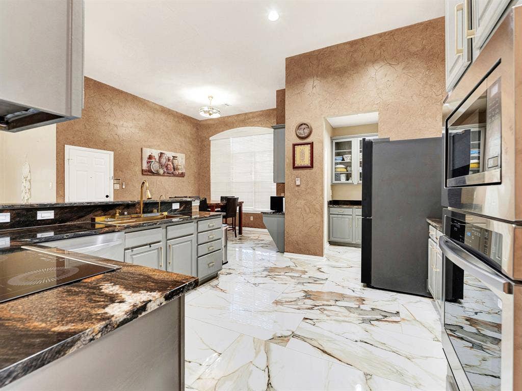 A tucked-away cabinet alcove adds extra kitchen storage without crowding the main workspace, keeping serving essentials conveniently nearby. Pull out your favorite dishes and prepare a special meal for visiting friends.