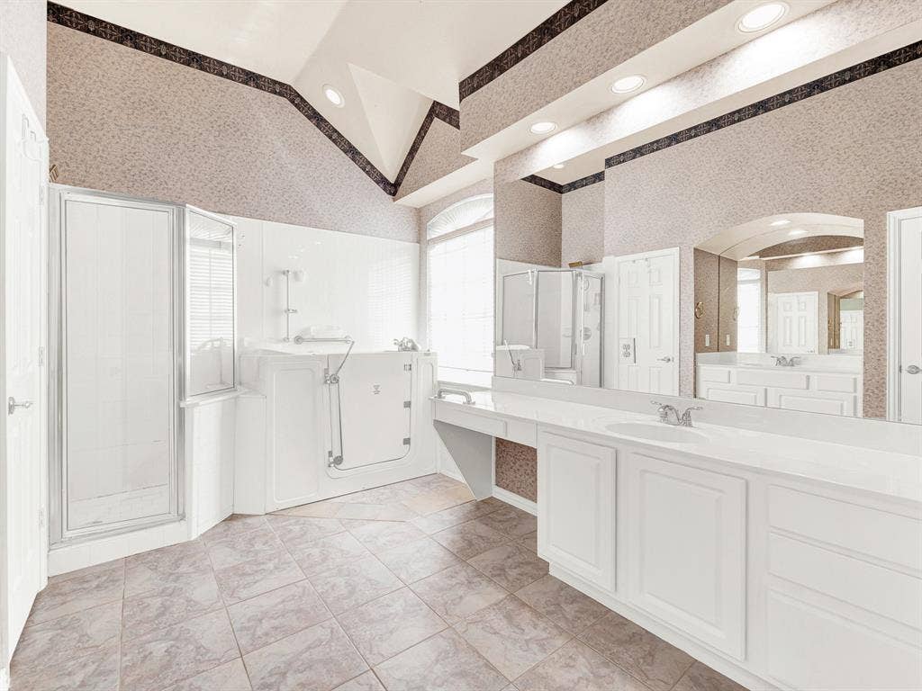 Broad wall space and an uncluttered path to the adjoining bathroom give the primary bedroom flexibility for your own arrangement. Get ready for an evening out at a comfortable pace in your private retreat.