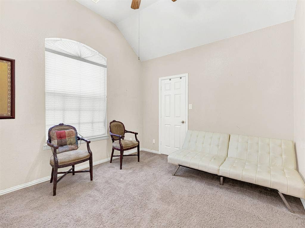 A tall arched window fills this bedroom with soft daylight, while the vaulted ceiling gives it an open, airy feel. Offer guests a welcoming retreat where they can unpack, relax, and enjoy a restful night.