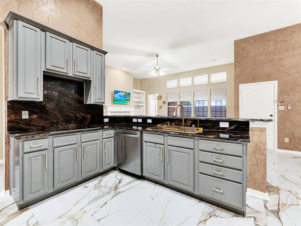 Upper transom windows draw daylight into the connected kitchen and living area, keeping the space bright while preserving broad backyard views below. Pack a picnic lunch while the rest of the household gets ready for an afternoon adventure.