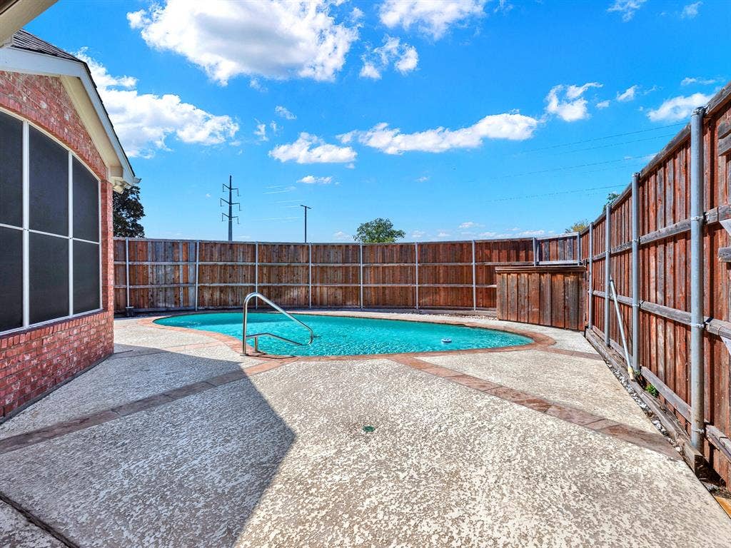 A generous poolside deck offers room for outdoor dining and lounging, with tall fencing enclosing the sunlit backyard and no neighbors behind. Spend a Saturday floating beneath the open sky, then gather for grilled favorites just steps from the water.