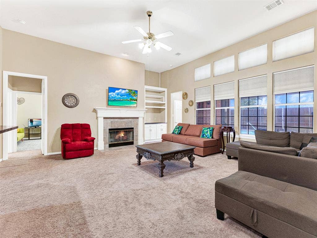 A white mantel and tiled fireplace create a welcoming focal point, bringing warmth to the spacious family room. Gather around on a chilly night and share the best moments of everyone’s day.
