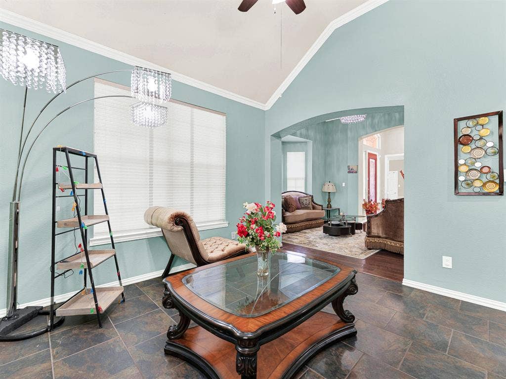 White crown molding follows the room’s angled ceiling, emphasizing its height without losing a sense of intimacy. Spend a quiet Sunday working on a puzzle as the afternoon slips by.