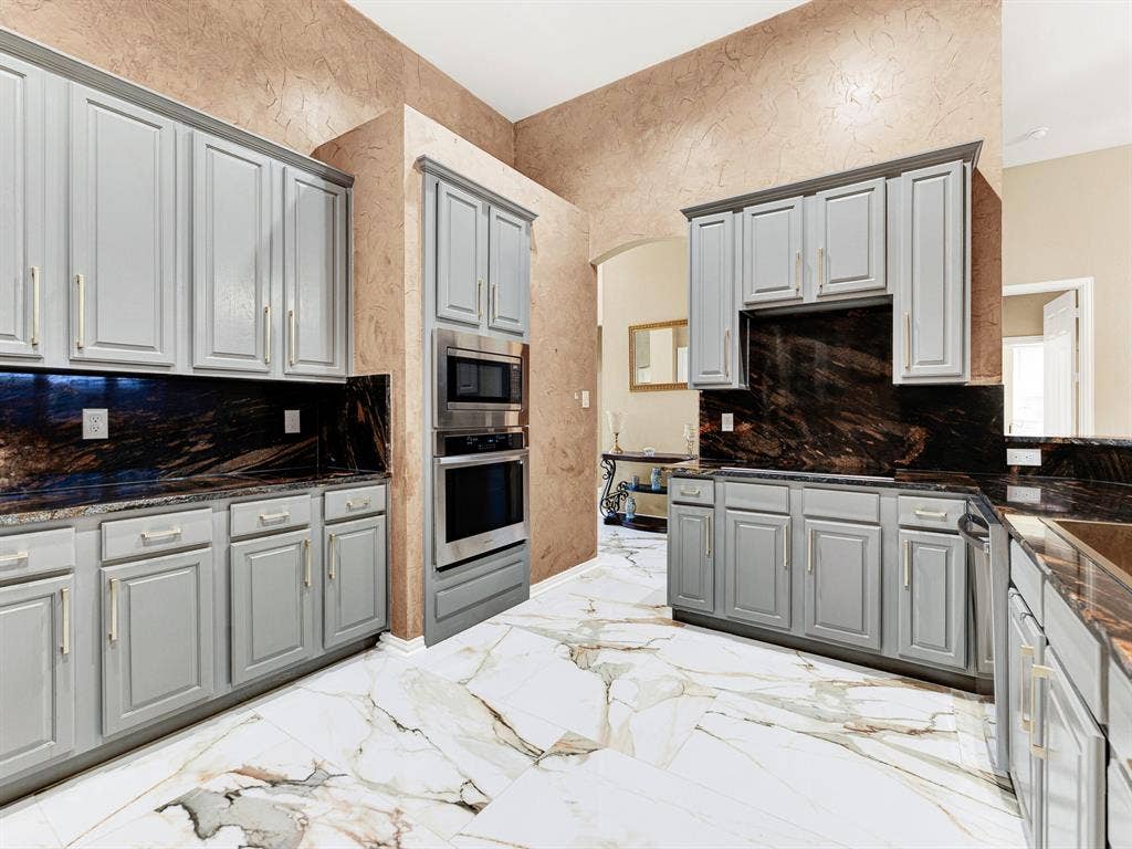 New 24-by-36-inch tile flooring installed in 2026 brings sweeping veining and a bright, polished finish to the kitchen. Gather ingredients for homemade pizza and enjoy an evening of cooking together.