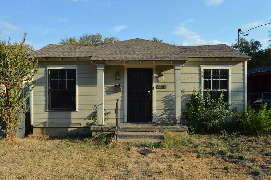 Exterior with horizontal siding, a pitched shingle roof, and a covered porch entry