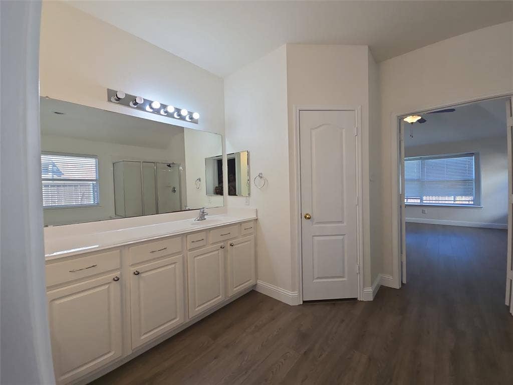 1545 Crystal Pass, Allen, TX 75002 Dual vanity with a single sink, an expansive wall mirror, and a built-in medicine cabinet