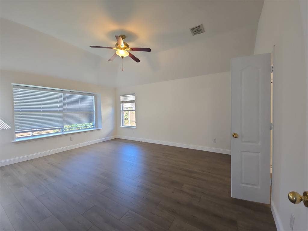 1545 Crystal Pass, Allen, TX 75002 Vaulted ceiling, wood-finish flooring, ceiling fan with integrated lighting, multiple windows with blinds, and a paneled interior door