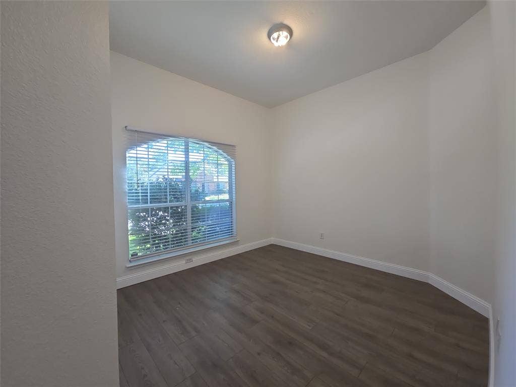 1545 Crystal Pass, Allen, TX 75002 Room featuring wood-finish flooring, an arched window with blinds, and recessed lighting