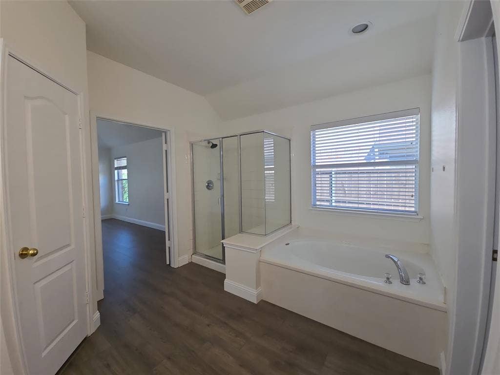 1545 Crystal Pass, Allen, TX 75002 Enclosed glass shower, built-in soaking tub, wood-finish flooring, and recessed ceiling lighting