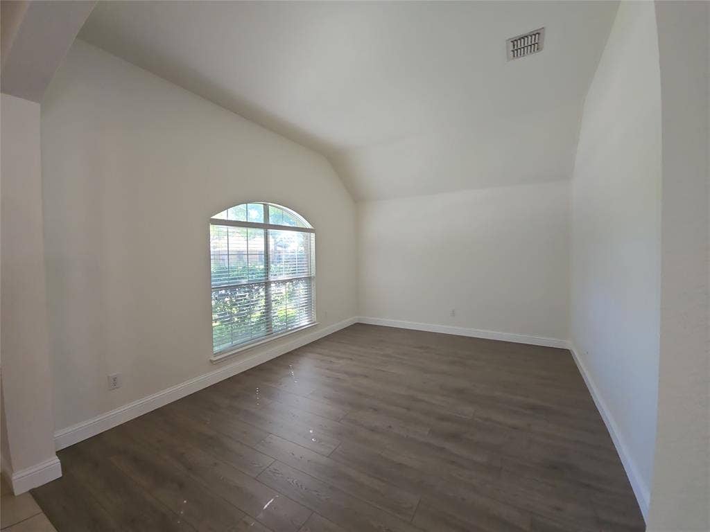 1545 Crystal Pass, Allen, TX 75002 Vaulted ceiling room featuring wood-finish flooring and an arched window with blinds