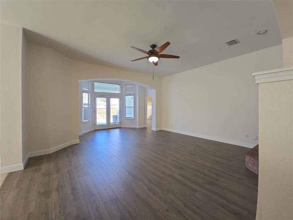1545 Crystal Pass, Allen, TX 75002 Spacious living area featuring wood-finish flooring, an arched doorway, and a ceiling fan