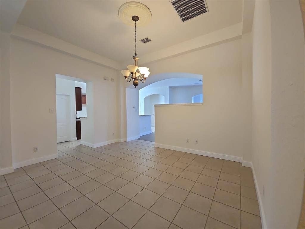 1545 Crystal Pass, Allen, TX 75002 Recessed ceiling design, decorative ceiling medallion, multi-light chandelier, tile flooring, arched doorways