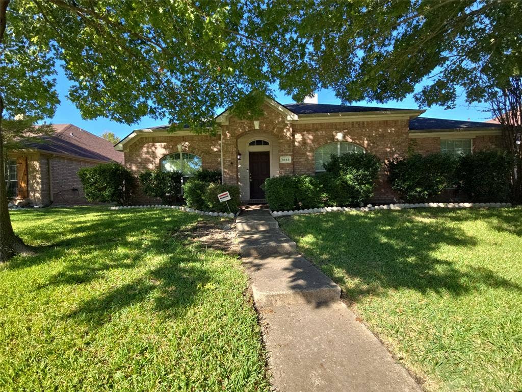 1545 Crystal Pass, Allen, TX 75002 Brick exterior with arched entry, mature front yard tree, and established perimeter shrubbery