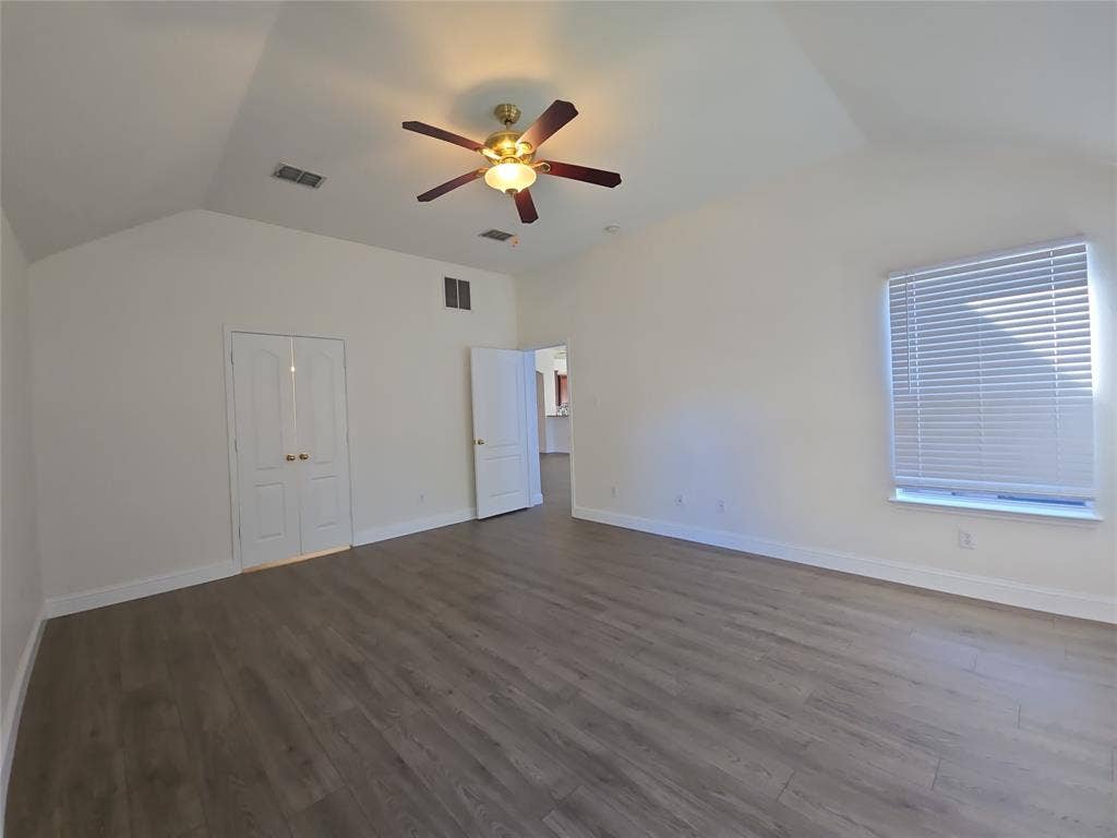 1545 Crystal Pass, Allen, TX 75002 Vaulted ceiling with a ceiling fan, wood-finish flooring, white double doors, and a window with blinds