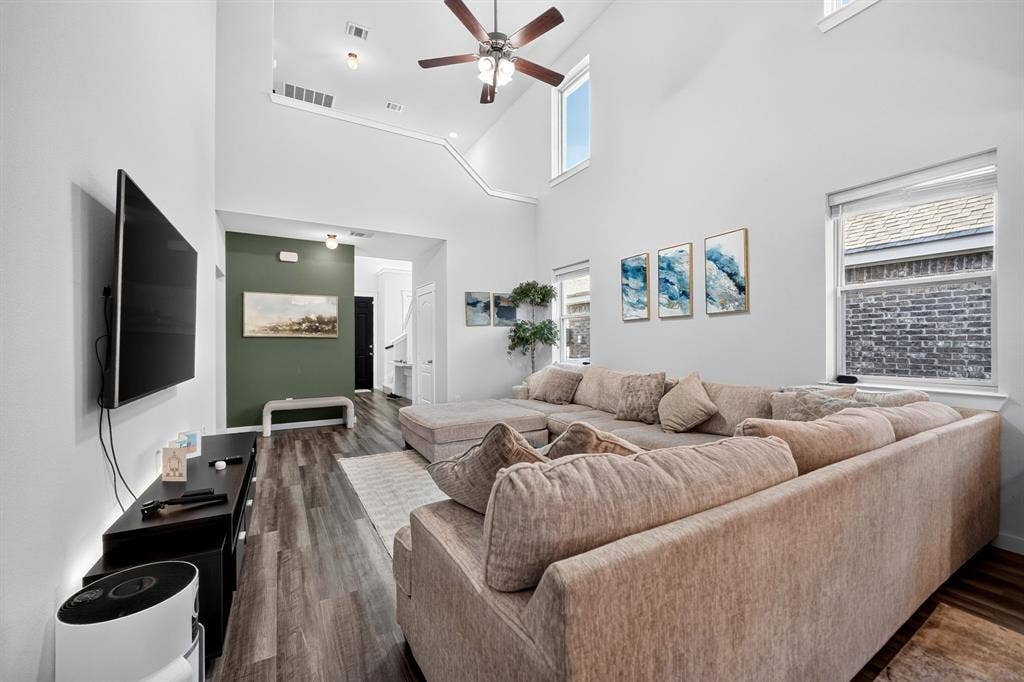 5534 Yarborough Drive, Forney, TX 75126 Open-concept living space featuring a ceiling fan, recessed lighting, and expansive wood-finish flooring throughout