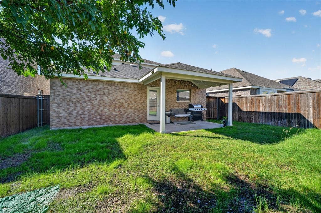 5534 Yarborough Drive, Forney, TX 75126 Private backyard with wood fencing, brick exterior, and a covered patio