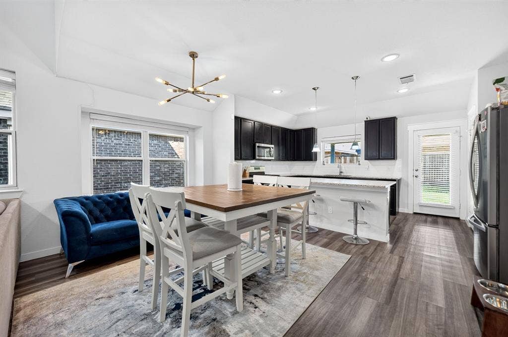 5534 Yarborough Drive, Forney, TX 75126 Open-concept living space with wood-finish flooring, a contemporary chandelier, and recessed lighting