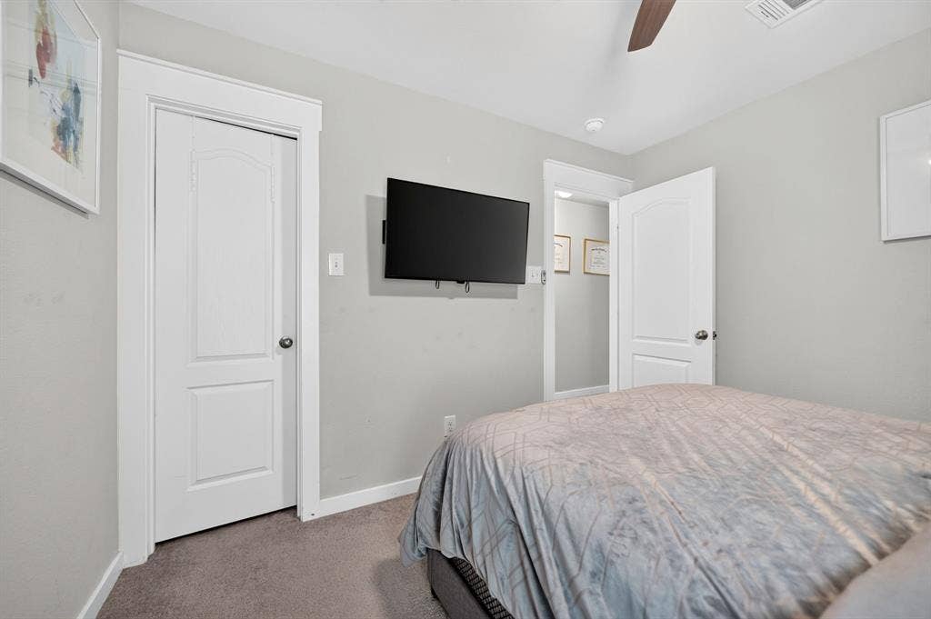 5534 Yarborough Drive, Forney, TX 75126 Spacious secondary bedroom with neutral wall finishes, carpet flooring, and dual closet doors providing ample storage
