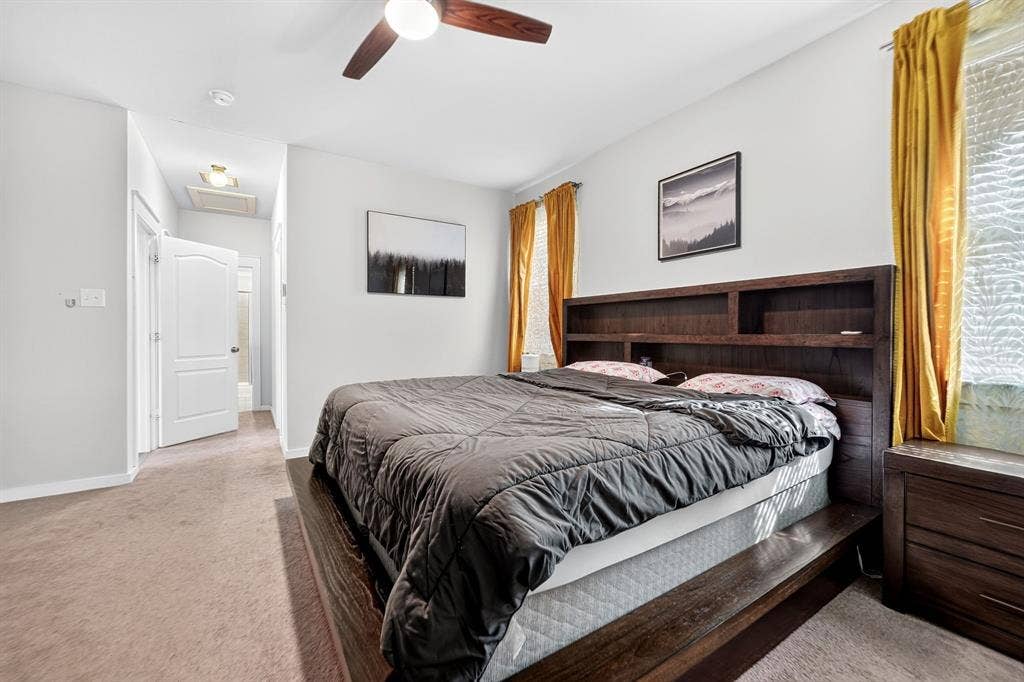 5534 Yarborough Drive, Forney, TX 75126 Primary Bathroom featuring a double vanity with black cabinetry and white quartz countertop, ceramic tile flooring, walk-in shower with frameless glass enclosure and subway tile surround, and recessed ceiling lighting