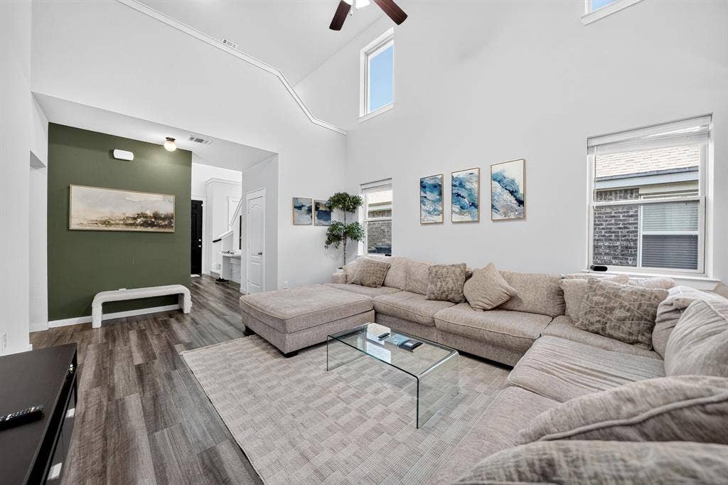 5534 Yarborough Drive, Forney, TX 75126 Vaulted ceilings featuring a ceiling fan, wood-finish flooring, and multiple windows