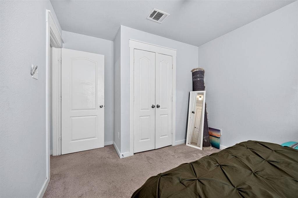 5534 Yarborough Drive, Forney, TX 75126 Spacious secondary bedroom with neutral wall finishes, carpet flooring, and dual closet doors providing ample storage