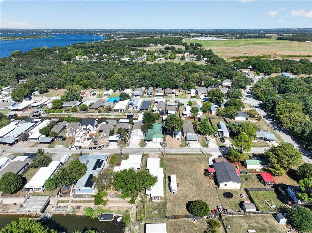 6624 Dayla Court, Granbury, TX 76049 Expansive water body, residential properties, treed areas, and open fields within the surrounding landscape