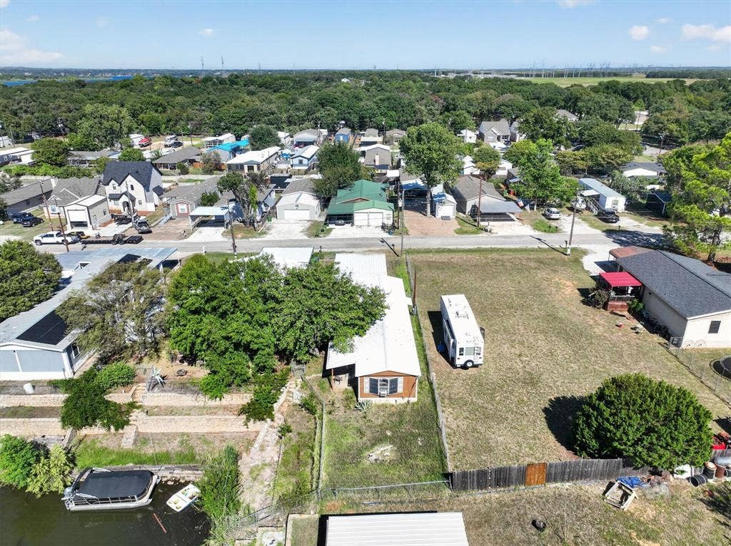 6624 Dayla Court, Granbury, TX 76049 Waterfront property featuring a private boat dock, mature trees, and a spacious yard