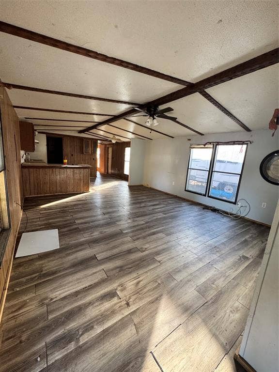 6624 Dayla Court, Granbury, TX 76049 Spacious room featuring wood-finish flooring, exposed ceiling beams, and a ceiling fan with integrated lighting